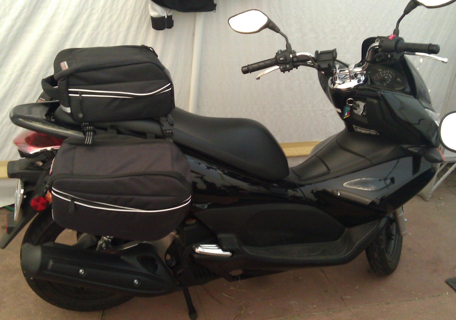 The passenger seat also provides a nice backrest. I've usually got a pair of sandals or other &quot;comfy&quot; shoes stashed in there.<br /><br />I'm considering getting another topper and figuring a way to use it as a tank bag. The GIVI bag is so hard to find and costs more, by itself, than this entire setup.