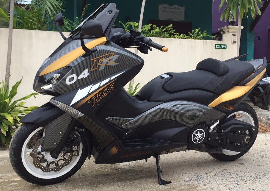 Yamaha Tmax thats in Matte Black, with gold designs, 14 panels Hydro dipped in Carbon Fiber and custom airbrushed tags, No stickers on this bike at all! <br />This was made for a customer that brought us a photo of a Yamaha Prototype concept. (Not sure if the bike in the pic he gave us even exisited or was a Photoshop deal!