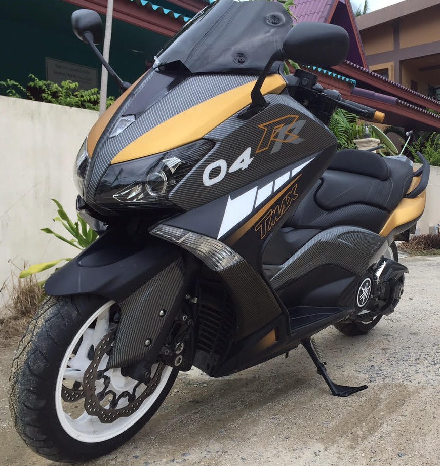 Yamaha Tmax thats in Matte Black, with gold designs, 14 panels Hydro dipped in Carbon Fiber and custom airbrushed tags, No stickers on this bike at all! <br />This was made for a customer that brought us a photo of a Yamaha Prototype concept. (Not sure if the bike in the pic he gave us even exisited or was a Photoshop deal!